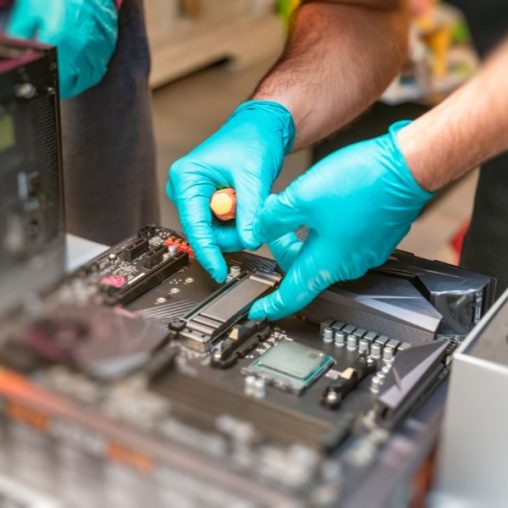 A repair man fixing a motherboard